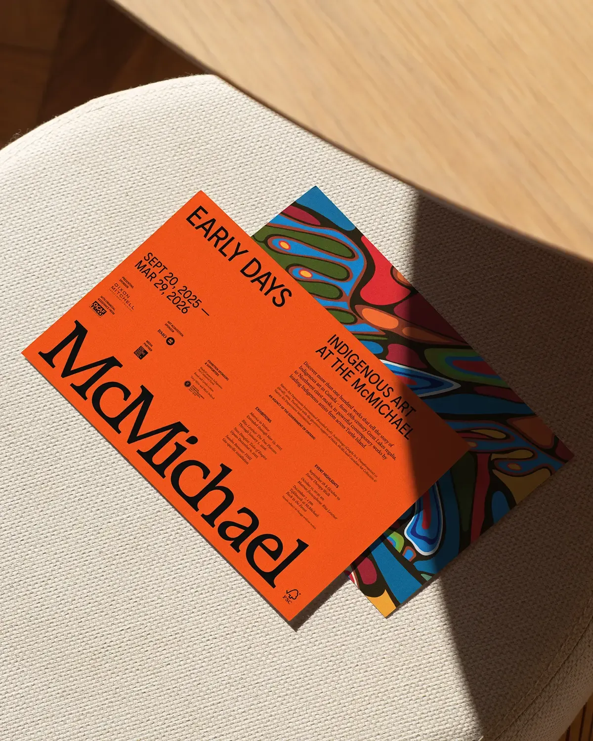 An orange art card that features the McMichael logo and the words