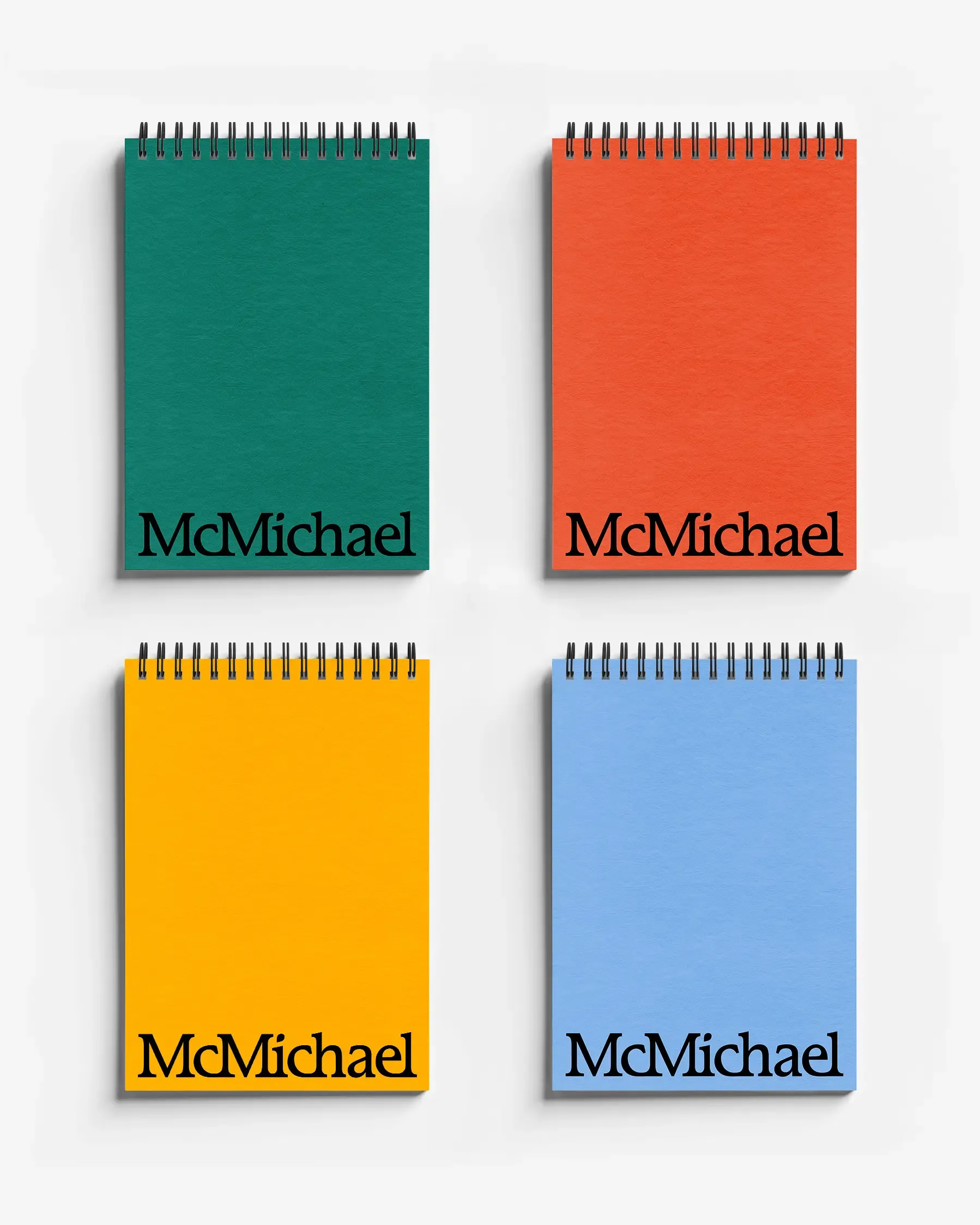 4 McMichael notebooks in green, red, yellow and blue