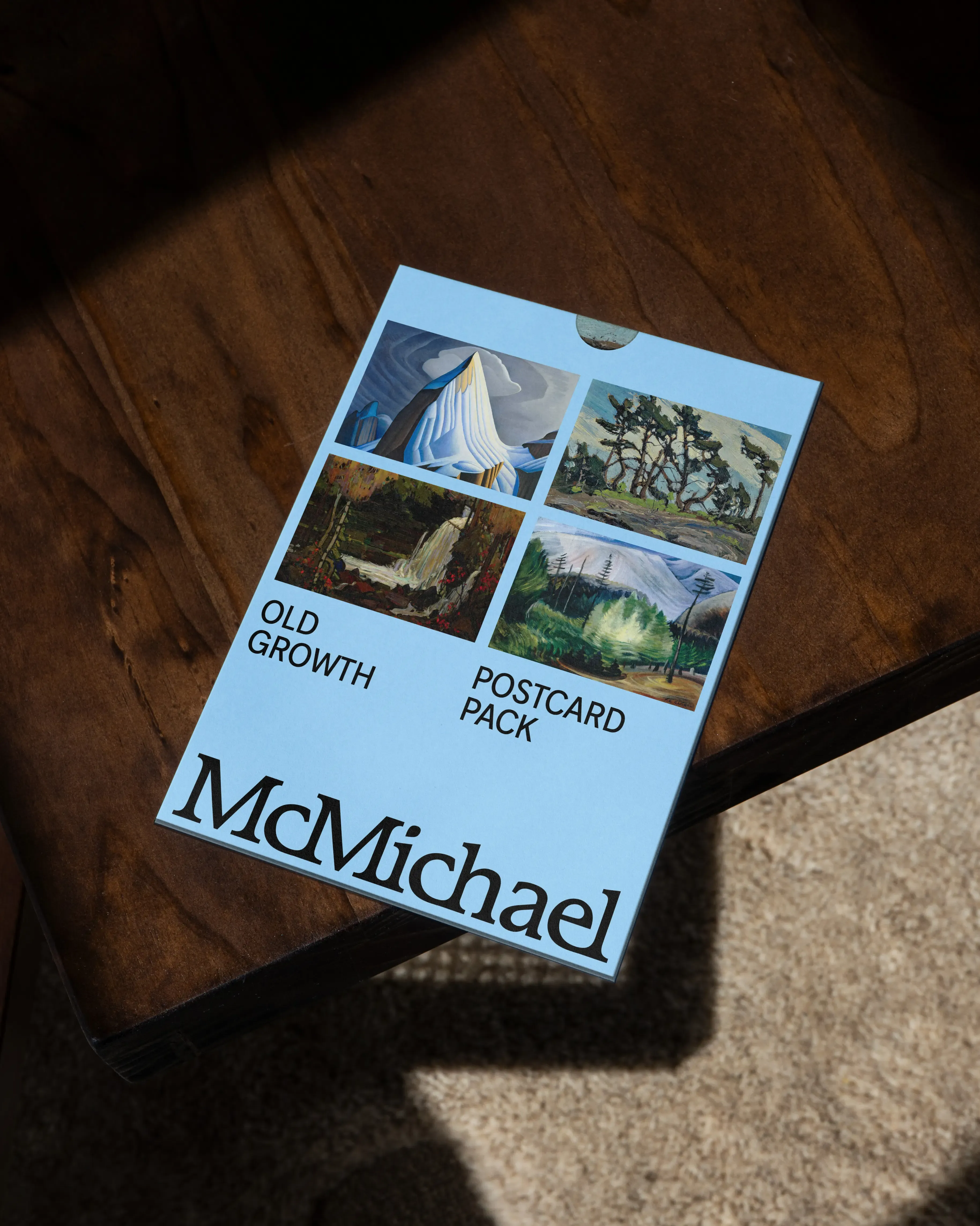 McMichael blue postcard with 4 paintings from old growth exhibition