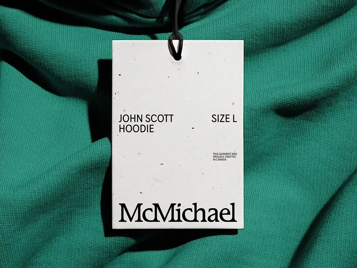 Closeup of a branded clothing tag on top of a green sweater